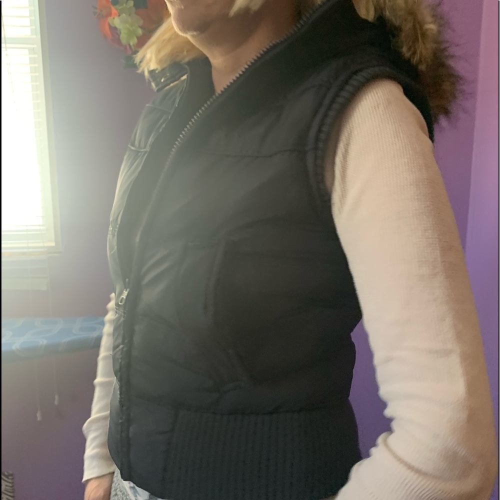 Gray women’s Winter Vest with a faux fur hood.